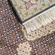 Handknotted wool oriental carpet with grid design, central motif, and black, gold, red border – luxury rug