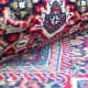 Handknotted wool oriental carpet in red with intricate motifs – luxury regal rug