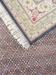 4890-05 Ebon Garden hand knotted wool carpet with black base, geometric patterned background, and floral border – luxury oriental rug