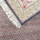 Ebon Garden hand knotted wool carpet with black base, geometric patterned background, and floral border – luxury oriental rug