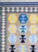 Flatwoven dhurrie with hexagon and inner link motifs in blue, yellow, brown, and grey – modern geometric rug