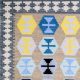 Flatwoven dhurrie with hexagon and inner link motifs in blue, yellow, brown, and grey – modern geometric rug