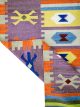 Flatwoven carpet with multicolor Aztec motifs on pink base – geometric artisanal rug