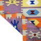 Flatwoven carpet with multicolor Aztec motifs on pink base – geometric artisanal rug